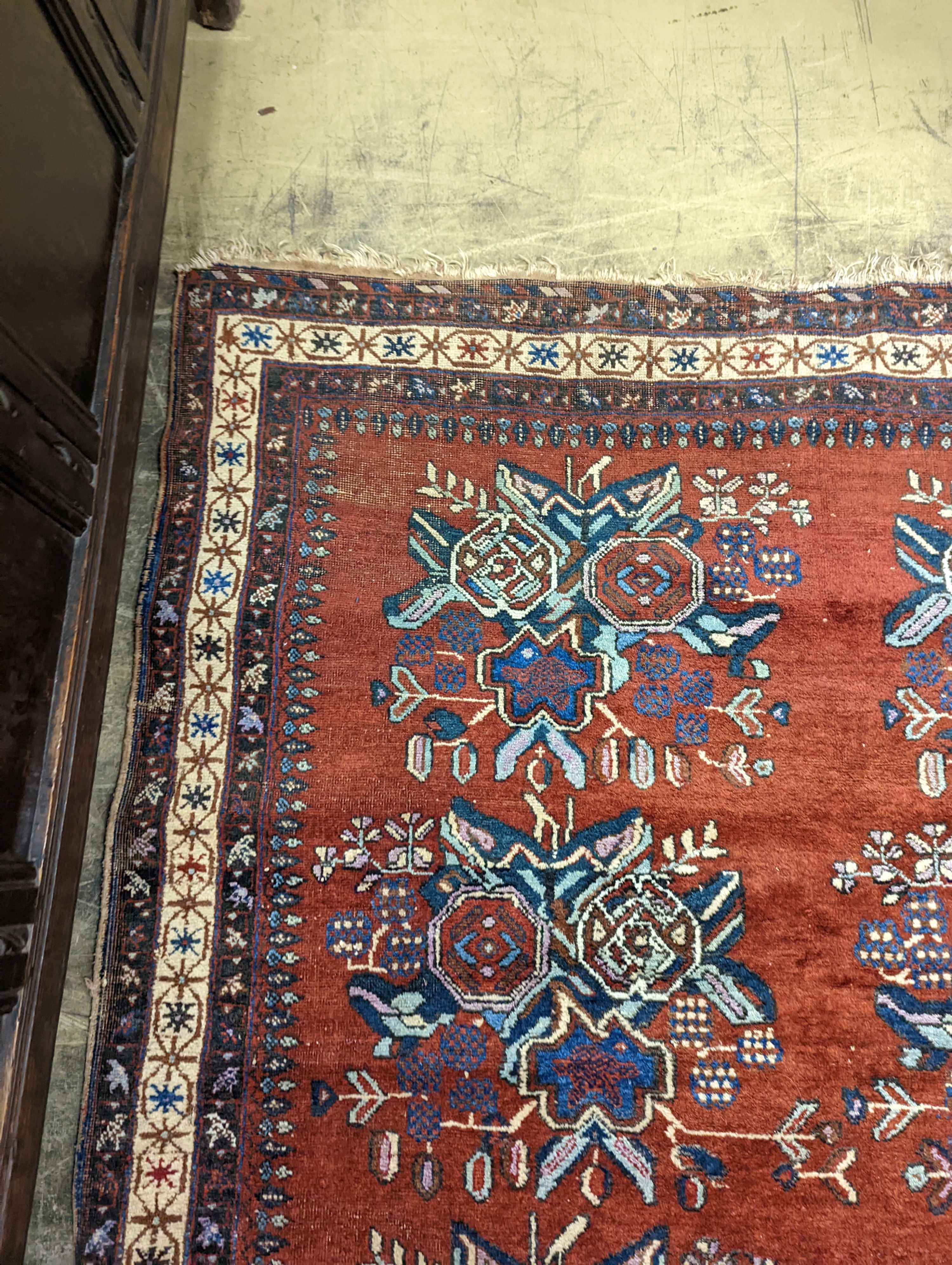 A North West Persian red ground rug with stylised foliate motifs, 185 x 157cm